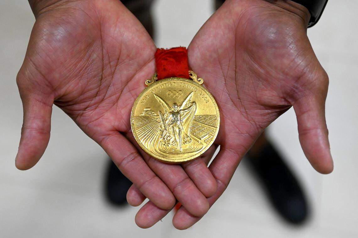 Former Olympic gold medalist swimmer Cullen Jones holds a gold medal he won at the 2008 Beijing Olympics on Wednesday, June 26, 2024. Jones earned two Olympic gold and two Olympic silver medals and represented Team USA in the Olympics in 2008 and 2012.