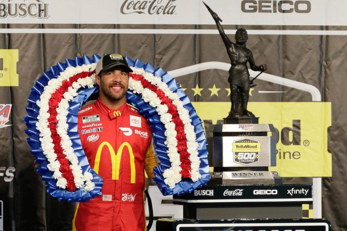 Bubba Wallace stands with the trophy after winning a NASCAR Cup series auto race Monday, Oct. 4, 2021, in Talladega, Ala. It was Wallace’s first win in the Cup series.