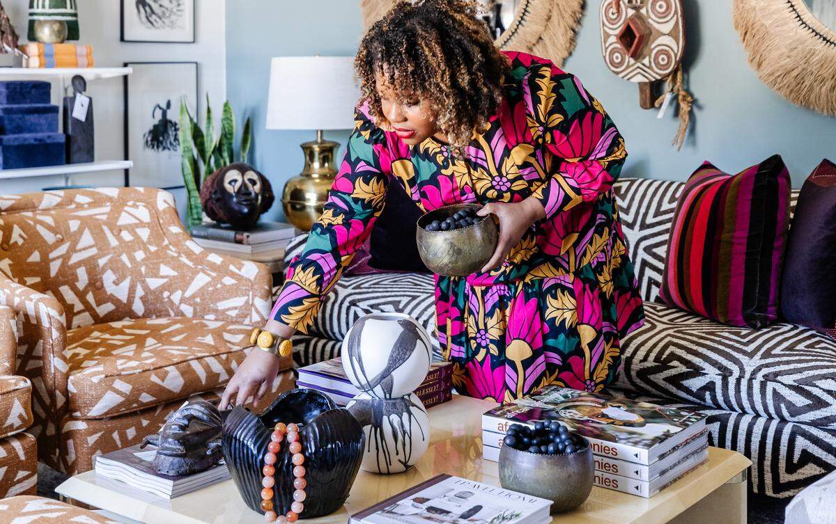 Ariene Bethea, owner and “chief huntress” with Dressing Rooms Interiors Studio in Charlotte, suggests evoking fall with fur throws and branches in vases.