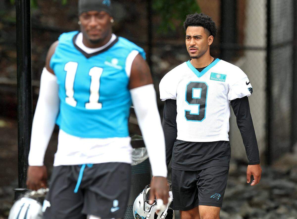 Carolina Panthers quarterback Bryce Young, right, walks to the team’s OTA practice on Tuesday, May 27, 2025.