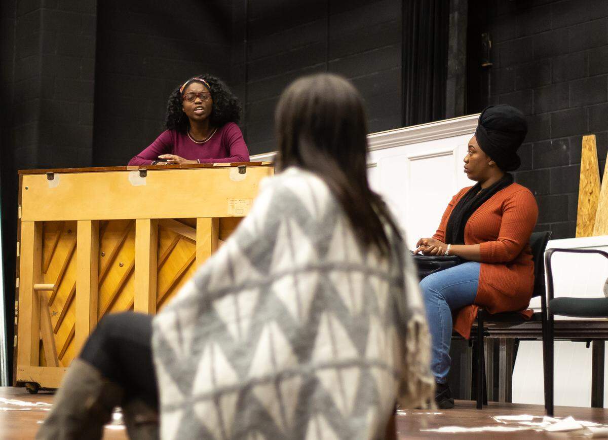 Nina, played by Destiny Stone, left, talks with Krystal Gardner, center and Erica Gardner during rehearsal.