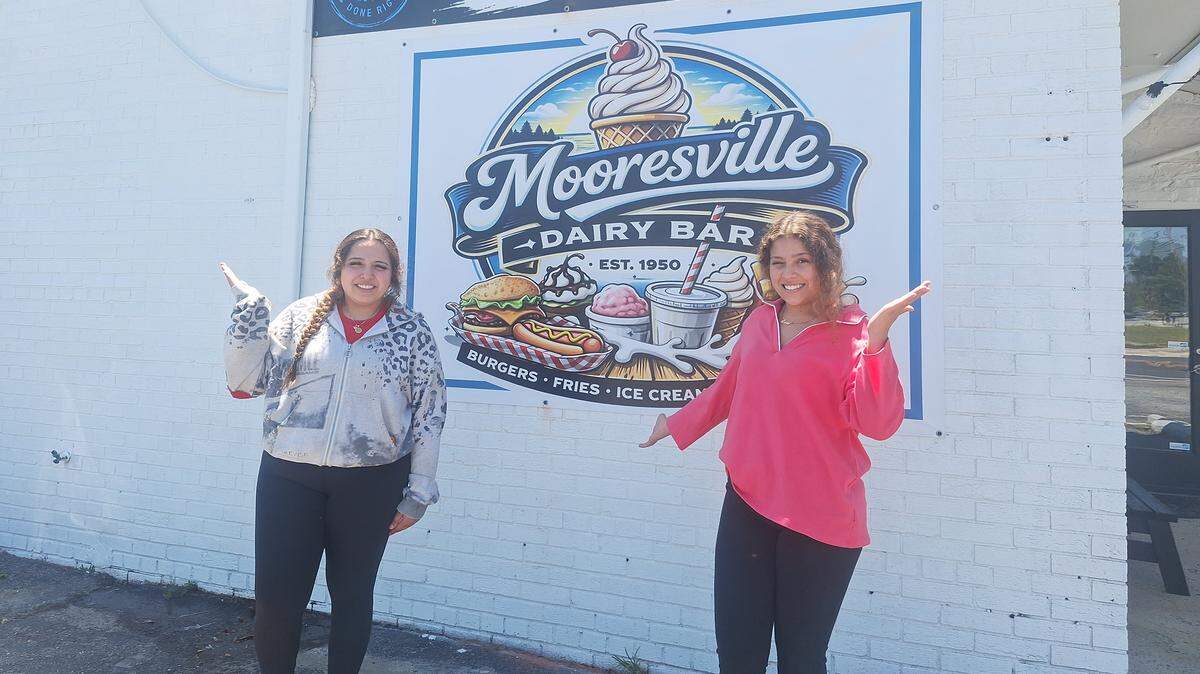 From left, siblings Jayda and Laila Riffle pose outside their mom Melissa Riffle’s 29 Grill Mooresville that opened Tuesday at 1043 N. Main St., less than a mile north of downtown.