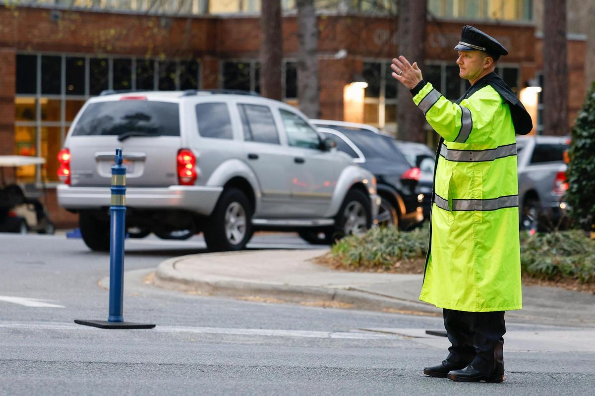 Charlotte-Mecklenburg Police Capt. Ryan Jackson directs traffic along Sardis Road in front of Charlotte Christian School in Charlotte, N.C., Thursday, March 31, 2022.