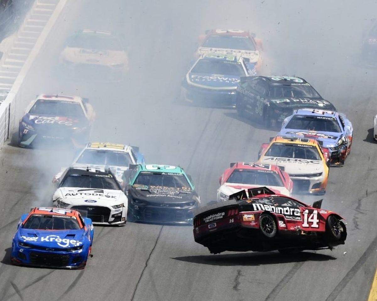 Chase Briscoe’s car (No. 14) gets a bit airborne as a crash ignites through the front dog-leg Sunday at Daytona.