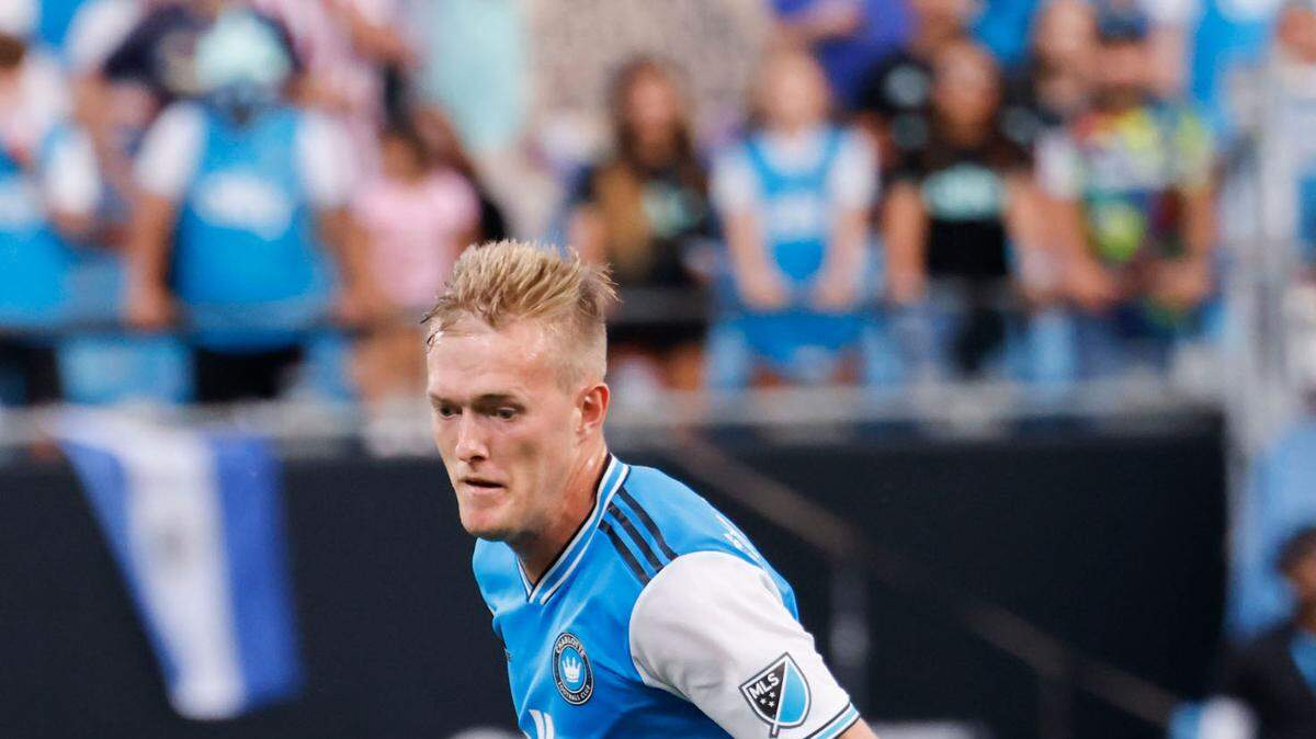 Charlotte FC forward Karol Świderski (11)pushes the ball upfield against Orlando City in the first half in Charlotte, N.C., Sunday, Aug. 21, 2022. 