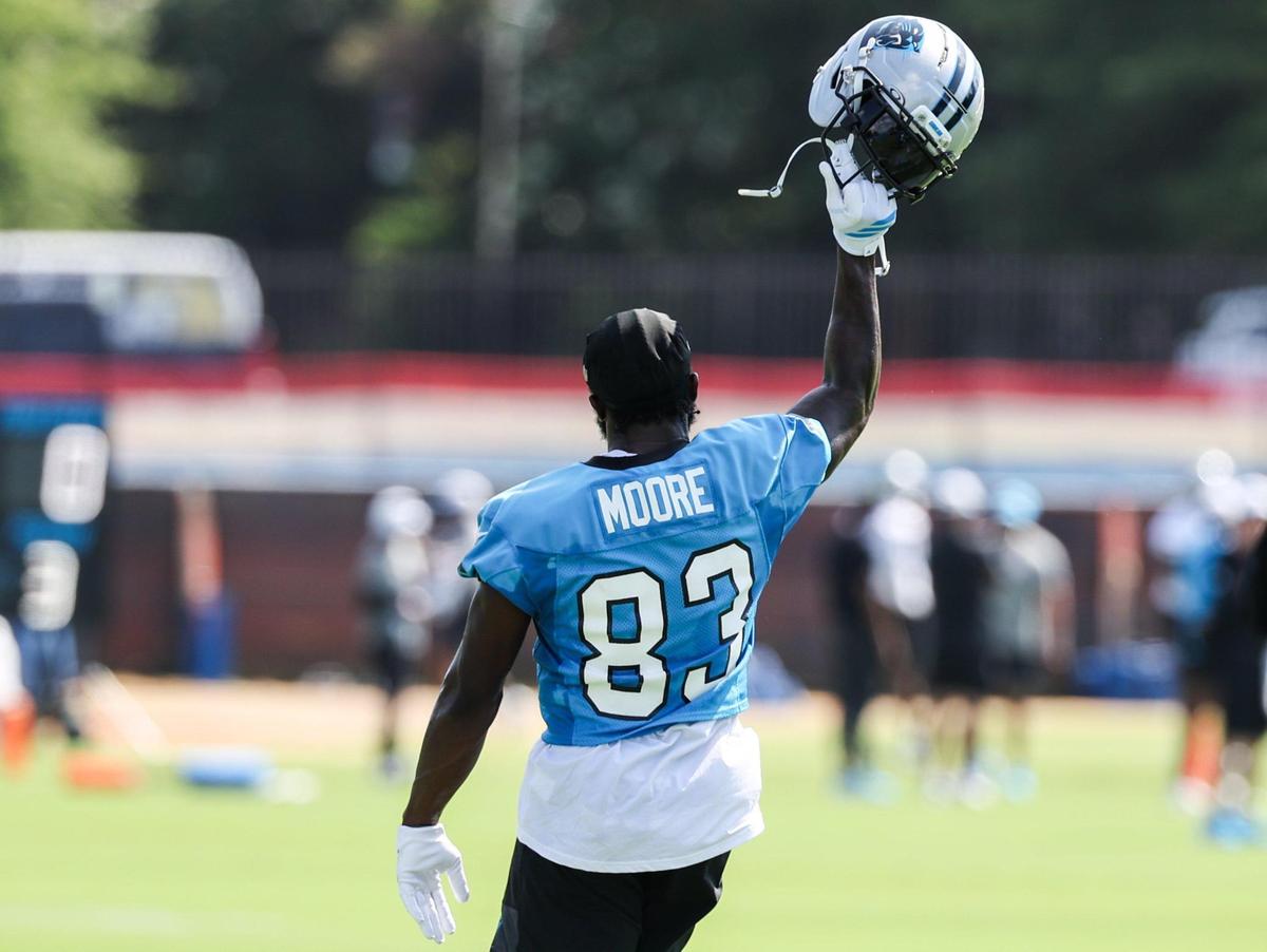 Panthers wide receiver David Moore pumps his helmet in the air as he dances between drills during training camp on July 24, 2025.