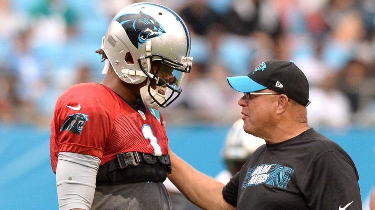 Carolina Panthers quarterback Cam Newton, left and team owner David Tepper, right, talk during the team’s Fan Fest at Bank of America Stadium on Aug. 2. Newton’s future with the Panthers isn’t certain, and columnist Scott Fowler wrote earlier this year that the team should move on from their franchist quarterback.