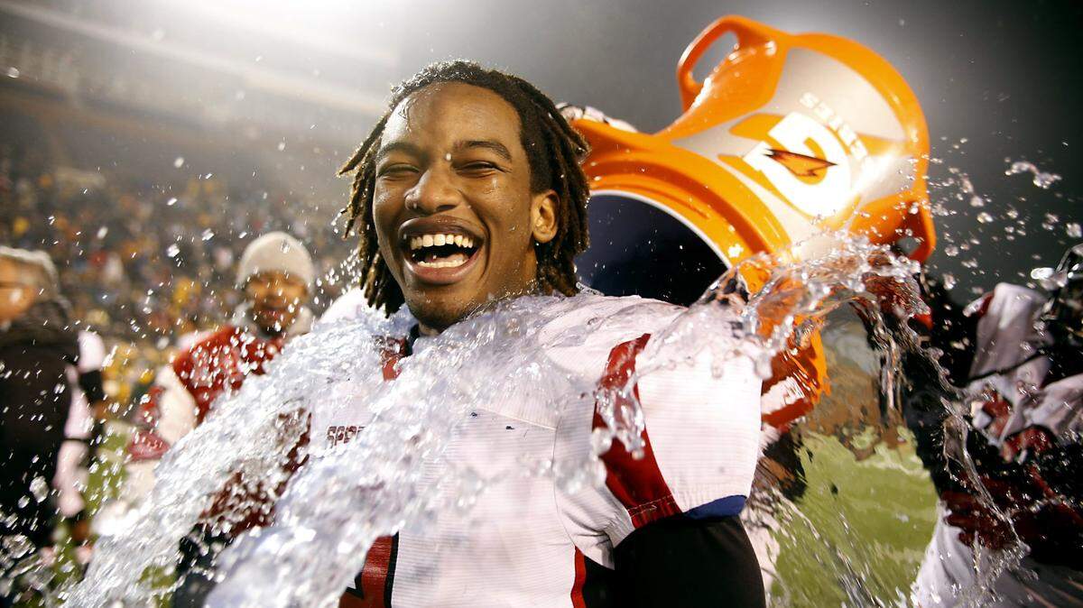 Former Southern High quarterback Kendall Hinton gets a celebratory bath following Southern Durham’s NCHSAA 3AA state championship win in 2013. Hinton will make an start for the Denver Broncos on Sunday.