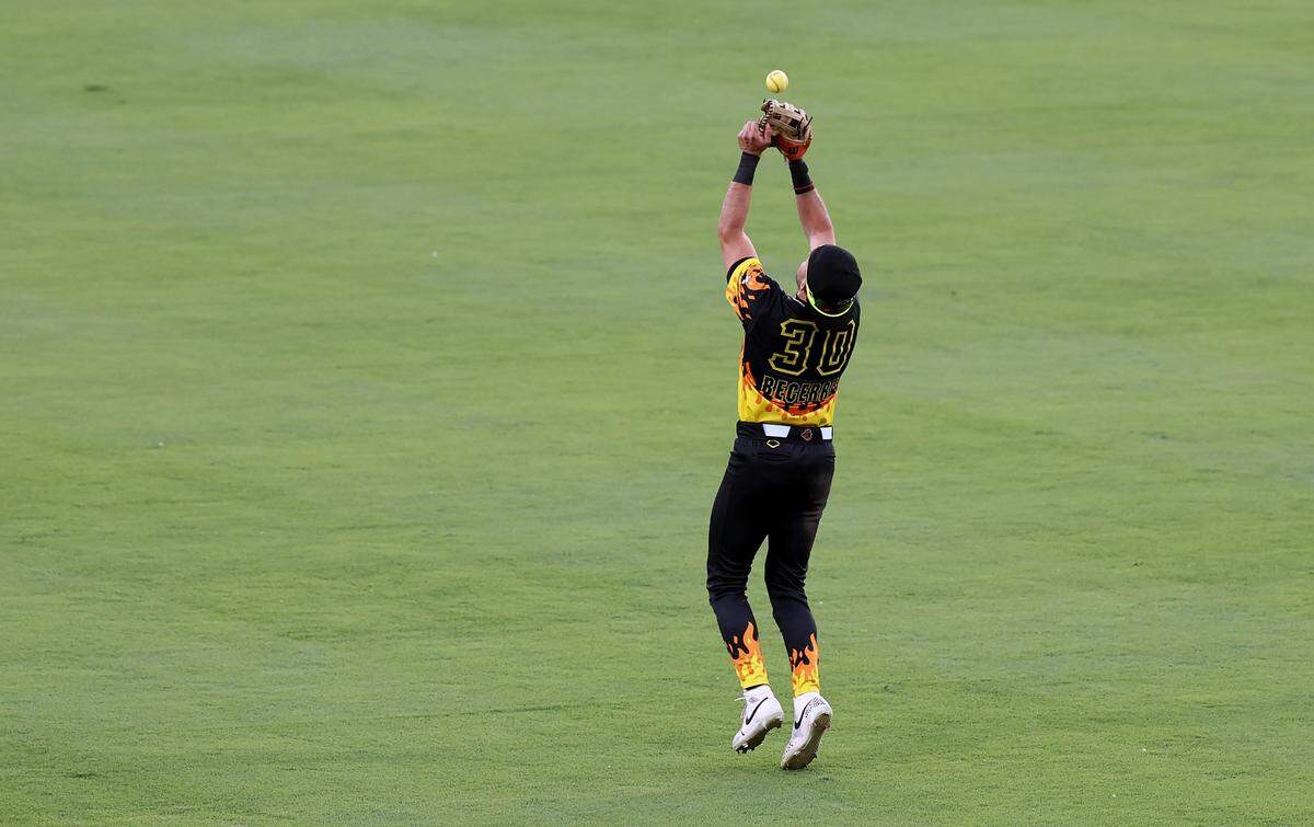 Firefighters centerfielder Armando Becerra kicks the ball back into the air with his glove prior to catching it on the second bump during action against the Texas Tailgaters at Truist Field in Charlotte, NC on Thursday, June 4, 2026. Banana Ball action returned to the Queen City with the Texas Tailgaters battling the Firefighters.