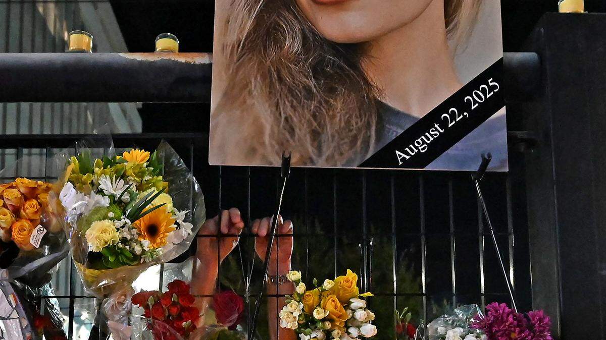 A man places flowers in a makeshift memorial for Iryna Zarutska at the East/West Blvd. Rail Station in South End in Charlotte, NC on Monday, September 22, 2025. Zarutska was stabbed to death while riding the Charlotte Lynx Blue Line on Friday, August 22, 2025. Community members came together to hold a vigil for the 23-year-old Ukrainian refugee.