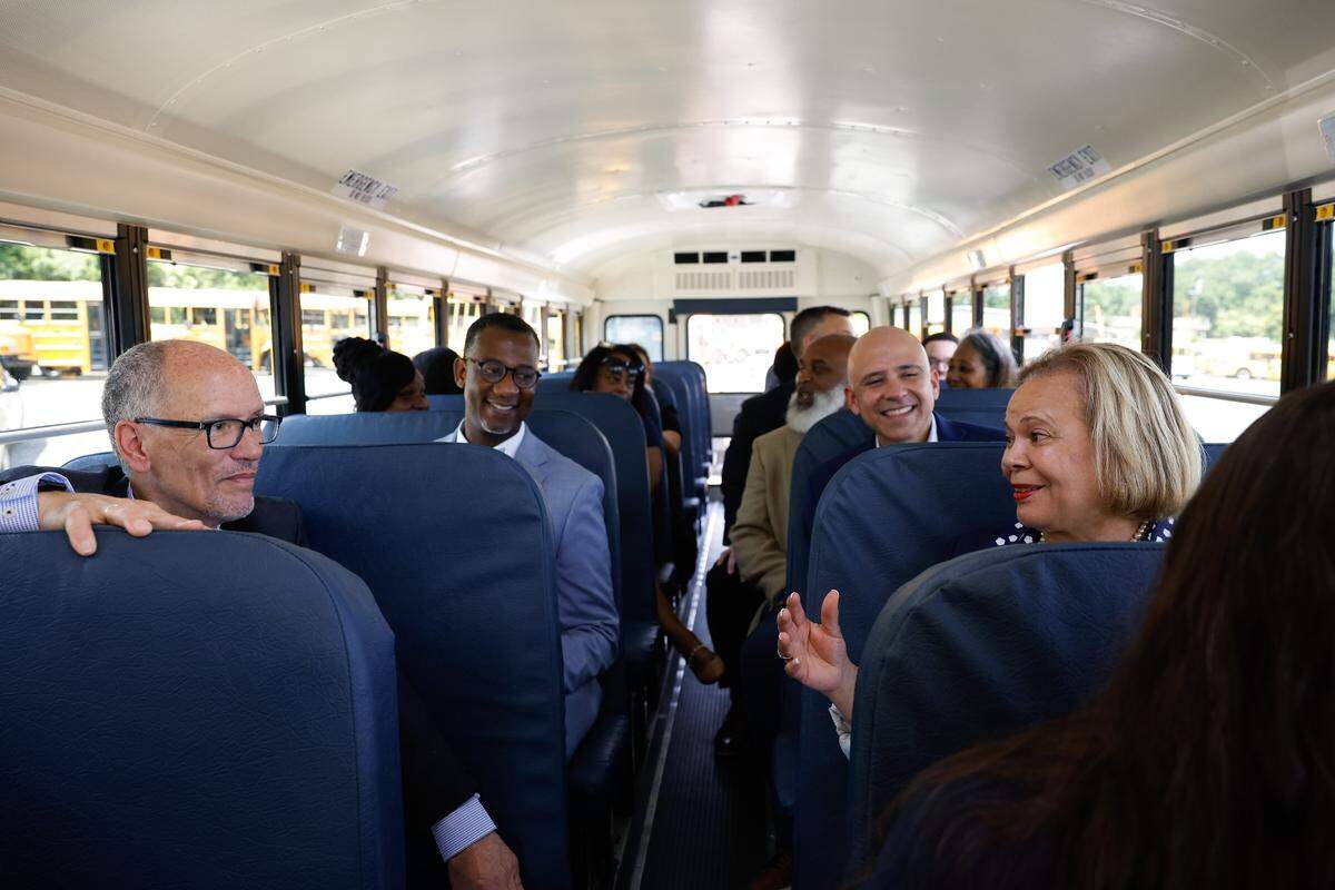 Tom Perez, Senior Advisor to President Biden and White House Director of Intergovernmental Affairs, left, listens to Mayor Vi Lyles, right, as they take a ride on an electric school bus during an event in Charlotte, on Thursday, June 6, 2024, to celebrate the award of additional grant funding to the Charlotte-Mecklenburg County School District from the U.S. Environmental Protection Agency’s 2023 Clean School Bus Program rebate competition. The funding will help school districts in nearly every state to replace diesel fueled school buses that have been linked to asthma and other conditions that harm the health of students and surrounding communities.   