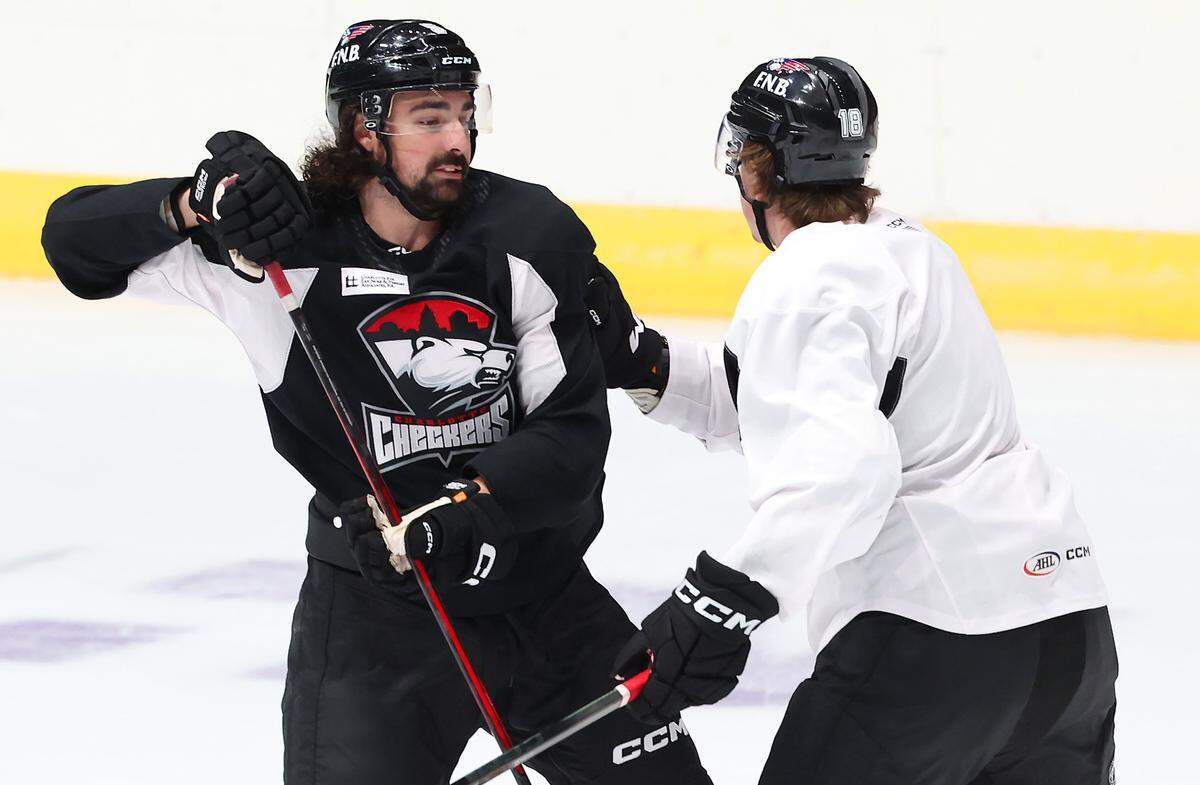Charlotte Checkers Trevor Carrick, left, fronts a teammate during practice at BoJangles Coliseum in Charlotte, NC on Thursday, October 9, 2025.
