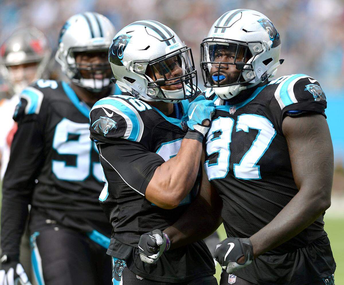 Carolina Panthers safety Eric Reid, left, congratulates defensive end Mario Addison, right, for his sack on Tampa Bay Buccaneers quarterback Ryan Fitzpatrick during second quarter action at Bank of America Stadium in Charlotte, NC. The Panthers defeated the Buccaneers 42-28.
