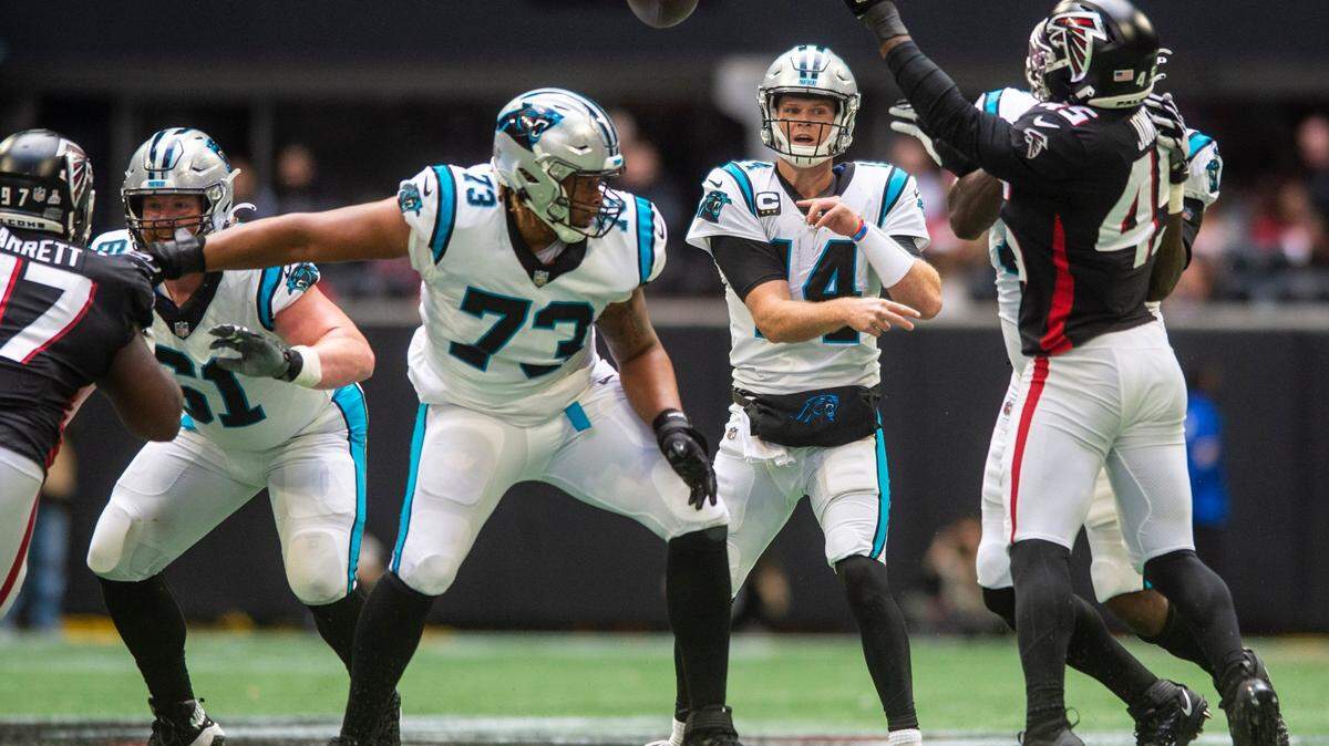 Panthers quarterback Sam Darnold, center, throws a pass during the game against the Falcons at Mercedes-Benz Stadium on Sunday, October 31, 2021 in Atlanta, GA.