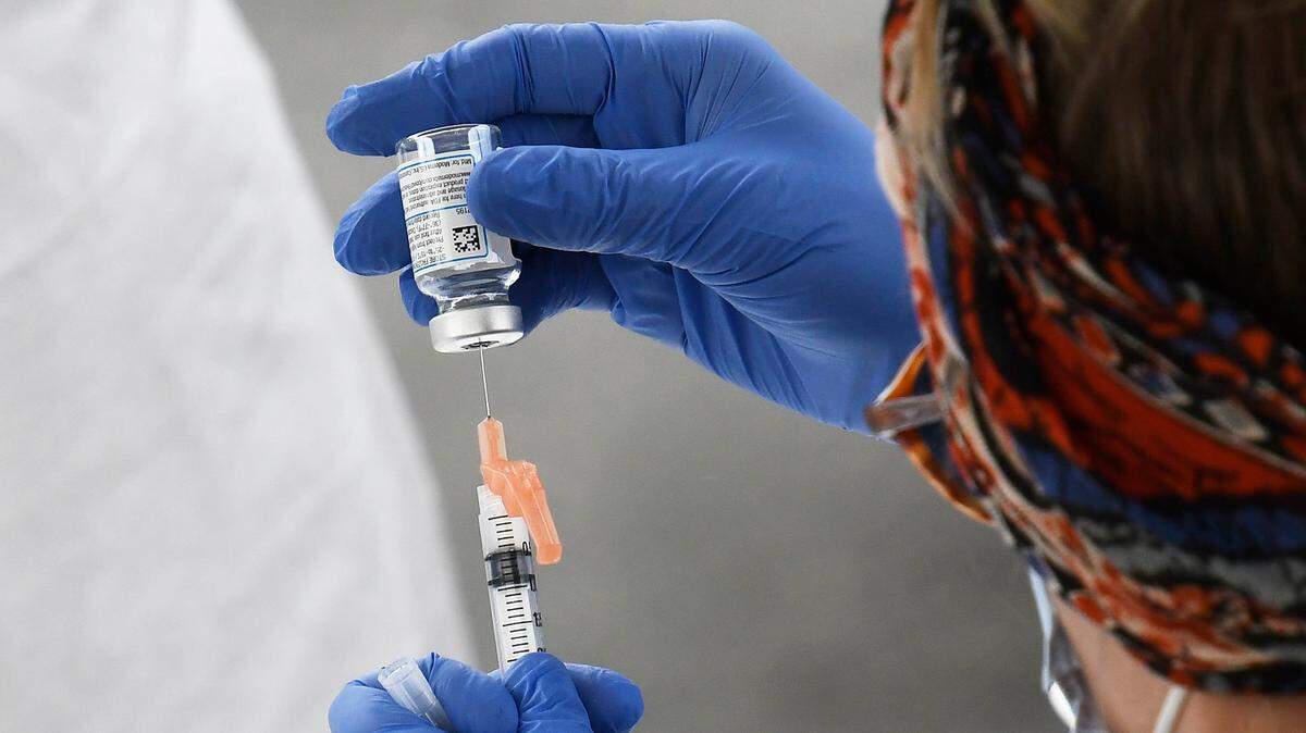 A Mecklenburg County Public Health professional prepares a COVID vaccination during a drive through event at he C.W. Williams Community Health Center on Friday, January 22, 2021. C.W. Williams Community Health Center, along with the Mecklenburg County Public Health Department offered patients of the health center COVID vaccinations through appointments.
