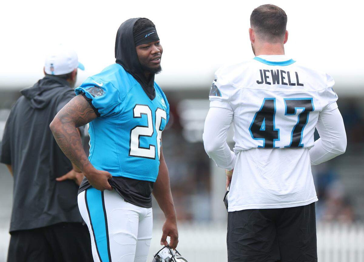 Carolina Panthers running back Rashaad Penny, left and linebacker Josey Jewell, right, talk prior to the start of training camp practice on Thursday, July 25, 2024.