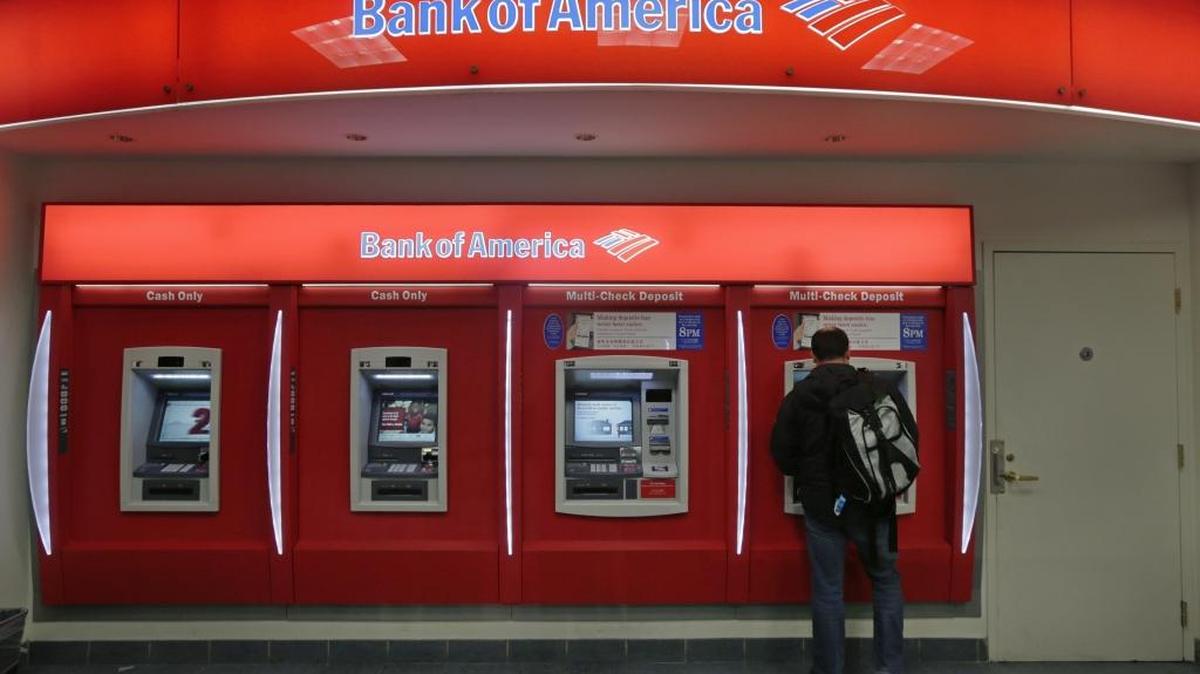 In this Dec. 13, 2012 photo, a customer stops at a Bank of America ATM office in Boston.