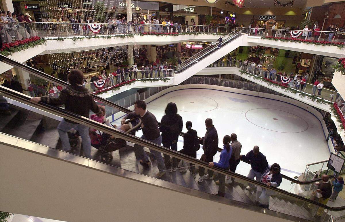 In this 2001 file photo, shoppers ride an escalator above the ice rink at Eastland Mall. Thousands of shoppers flocked to area malls to take advantage of a full shopping weekend before Christmas. TODD SUMLIN-STAFF