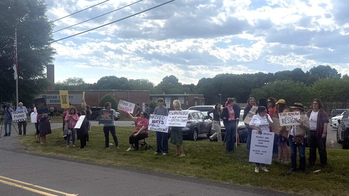 People lined the road before a Gaston County Schools Board of Education meeting to protest anti-Islamic social media statements by member Tod Kinlaw and call for more county education funding.