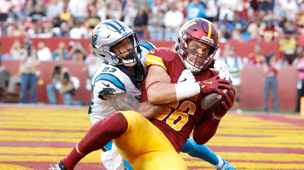 Oct 20, 2024; Landover, Maryland, USA; Washington Commanders tight end Zach Ertz (86) catches a touchdown pass as Carolina Panthers cornerback Dane Jackson (23) defends during the second quarter at Northwest Stadium. Washington won, 40-7.