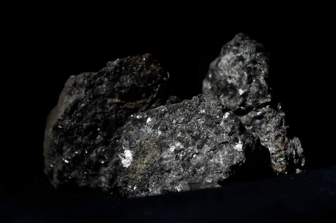 Piedmont Lithium&nbsp;in Belmont-based and Australia-based Sayona Mining proposed merger will come with a rebrand and new name, Elevra Lithium. Pieces of lithium sparkle in this ore sample placed in Prague, Czech Republic, in 2017. 