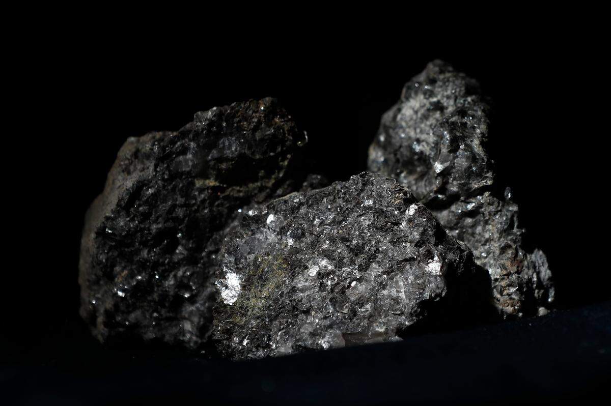 Pieces of lithium sparkle in this ore sample placed on a table in Prague, Czech Republic, in 2017. A company has proposed a mine for the key battery component near Cherryville, NC, just outside of Charlotte. But the proposal has met some opposition.