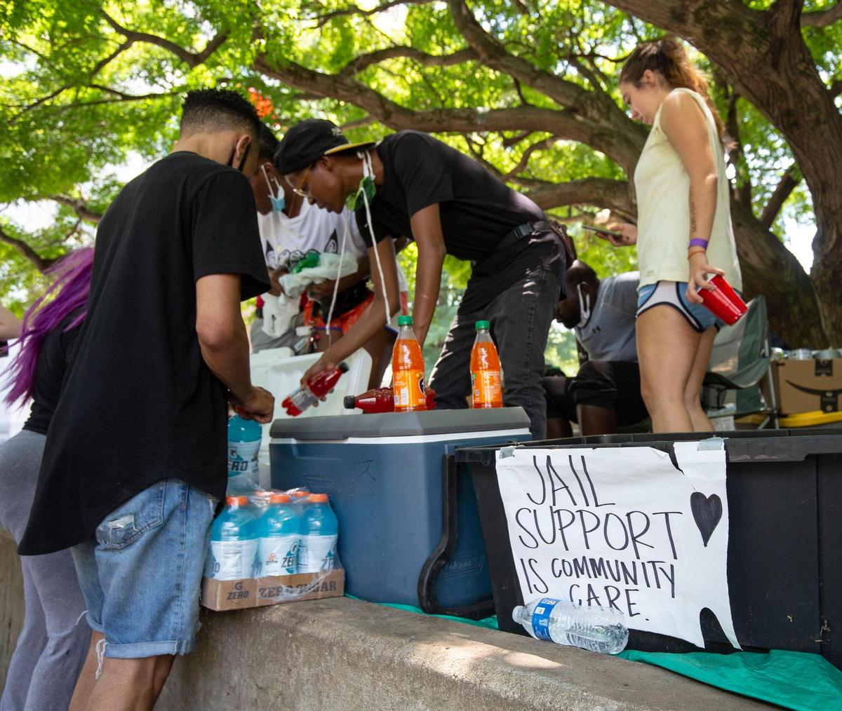 Volunteers with Jail Support and Charlotte Uprising restock drinks and other food items to distribute to those who are released from jail in Uptown Charlotte, NC on Monday, July 20, 2020. A large police presence was in front of the jail after the Charlotte Uprising group confronted SheriffÕs arresting a man outside the jail Monday afternoon.