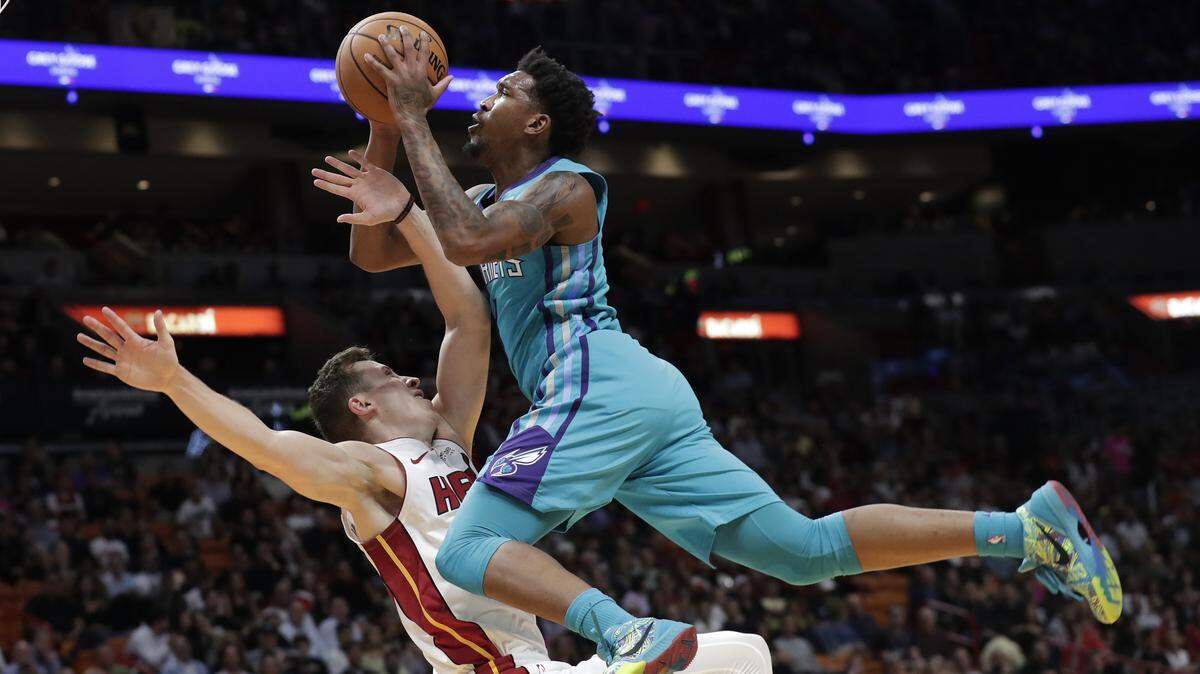 Charlotte Hornets guard Malik Monk, right, is fouled by Miami Heat forward Duncan Robinson during the first half of an NBA basketball game, Monday, Nov. 25, 2019, in Miami. (AP Photo/Lynne Sladky)