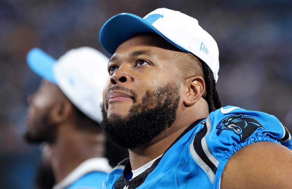 Carolina Panthers guard Robert Hunt watches a replay along the team's sideline during action against the Cleveland Browns on Friday, Aug. 8, 2025 at Bank of America Stadium in Charlotte, North Carolina.