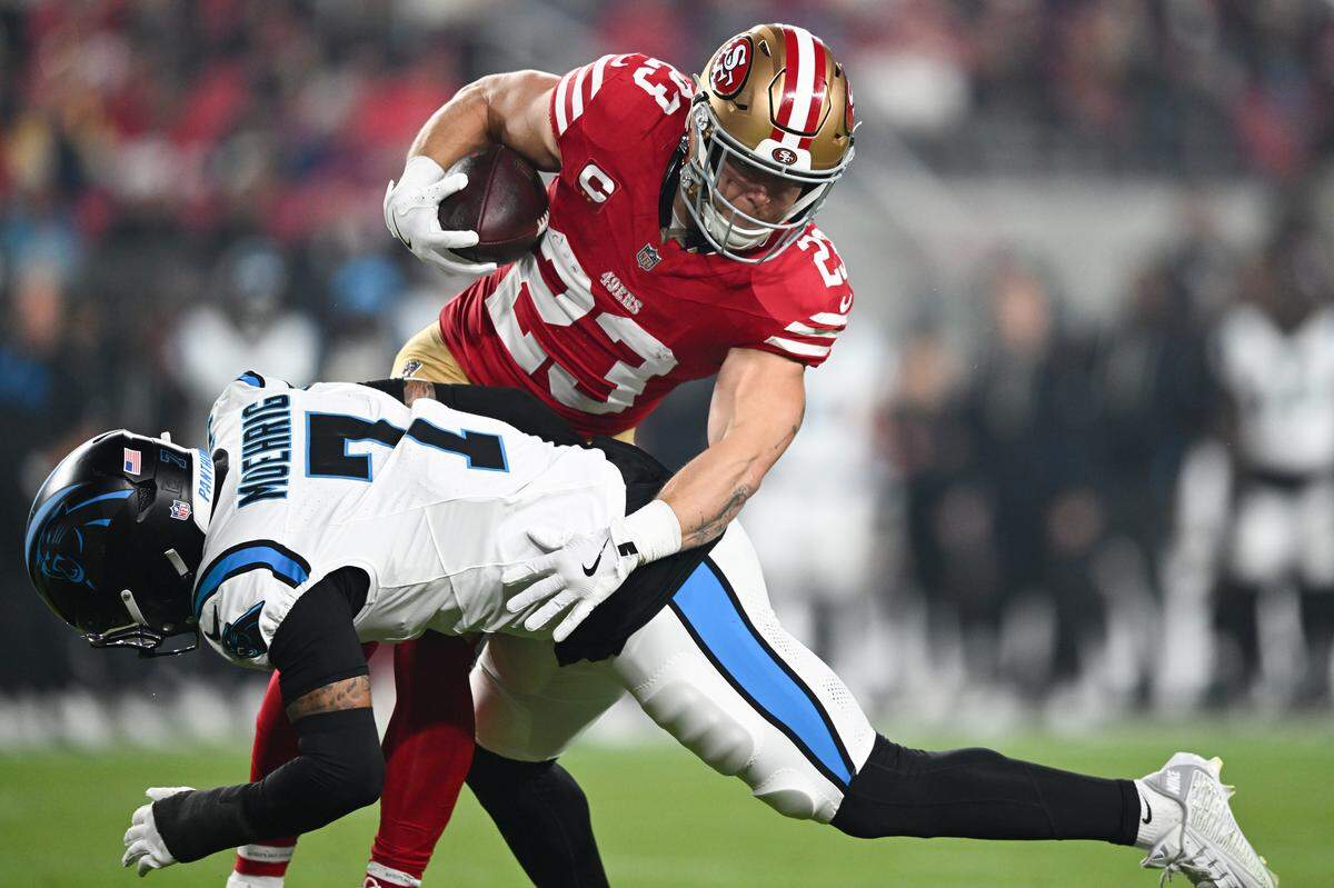 Christian McCaffrey (23) of the San Francisco 49ers is tackled by Tre'von Moehrig (7) of the Carolina Panthers in the first quarter of Monday’s game at Levi's Stadium.