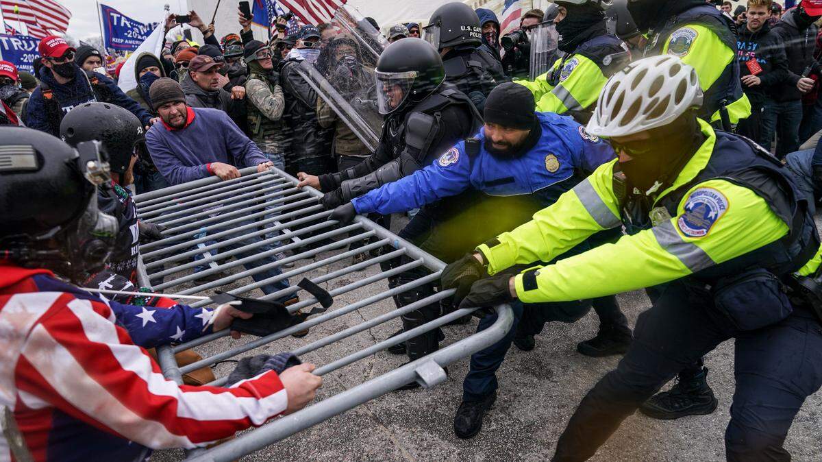 Pro-Trump rioters try to break through a police barrier at the US Capitol in Washington on January 6, 2021.