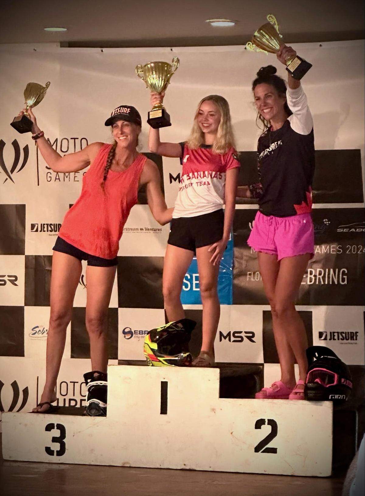 Anna Burk holds her first-place trophy after a U.S. MotoSurf race in Sebring, Florida, in late September.