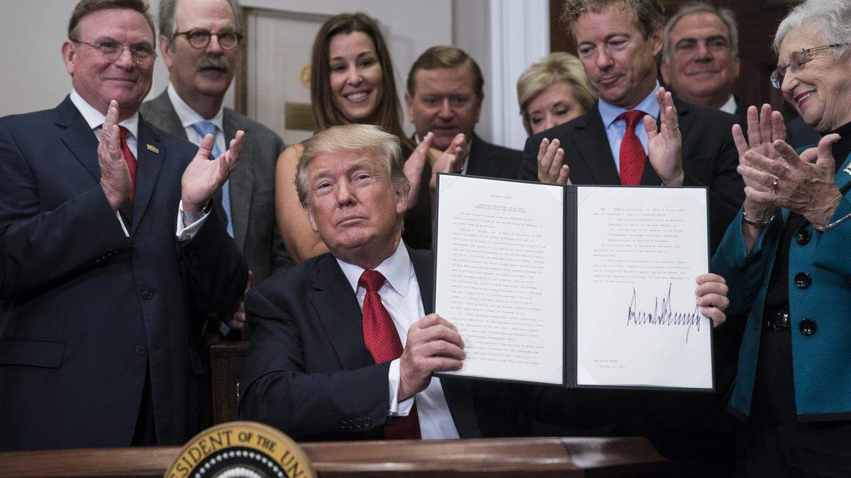 President Trump signs an executive order on health care at the White House in December.