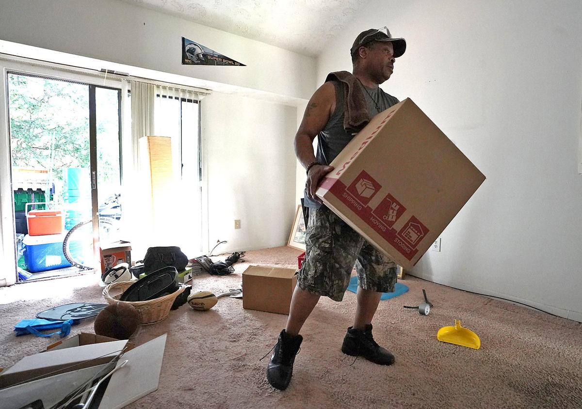 Kenneth Brooks, a resident of Lake Arbor Apartments on Tuckaseegee Road In Charlotte, NC carries a box of belongings to his car on Saturday, August 31, 2019. Residents have until Monday, September 30, 2019 to leave.