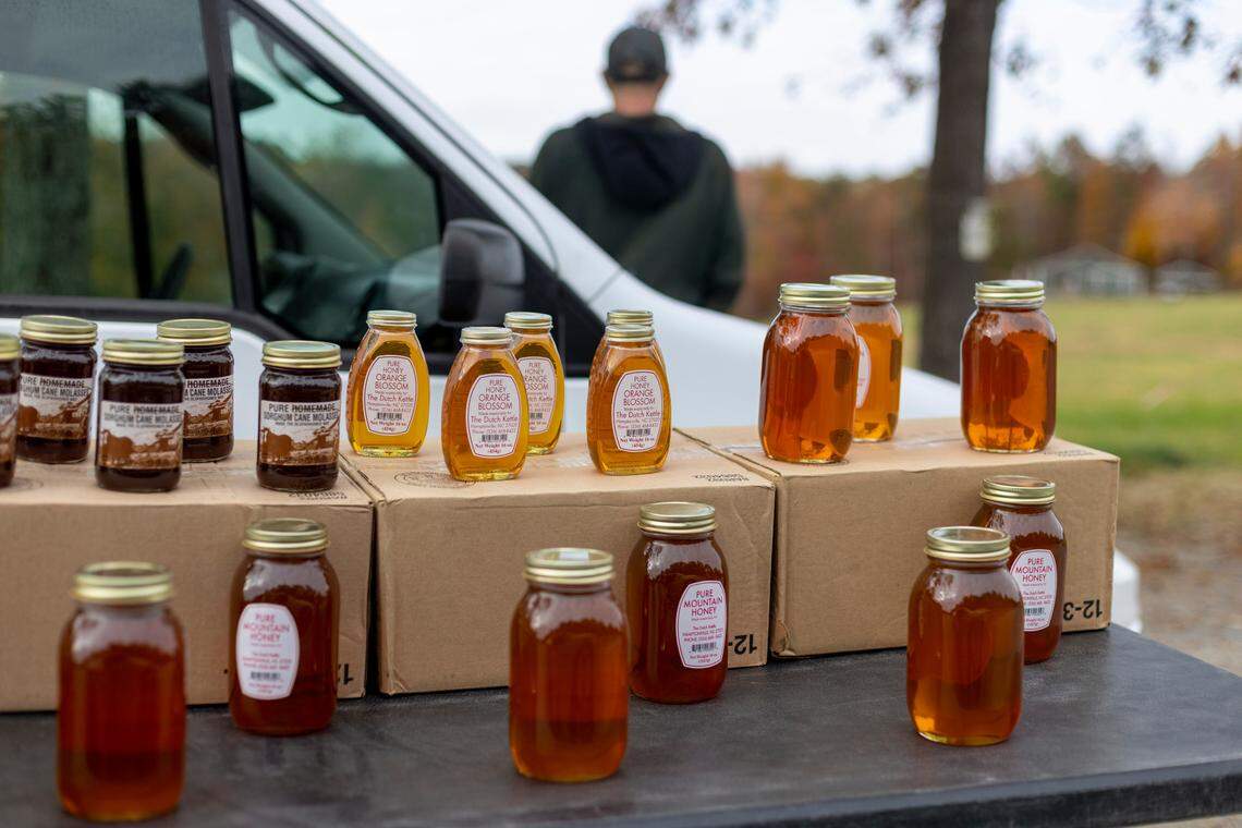 A honey salesman is set up along Old Cedar Falls Road on Thursday, October 27, 2022 in Asheboro, N.C.