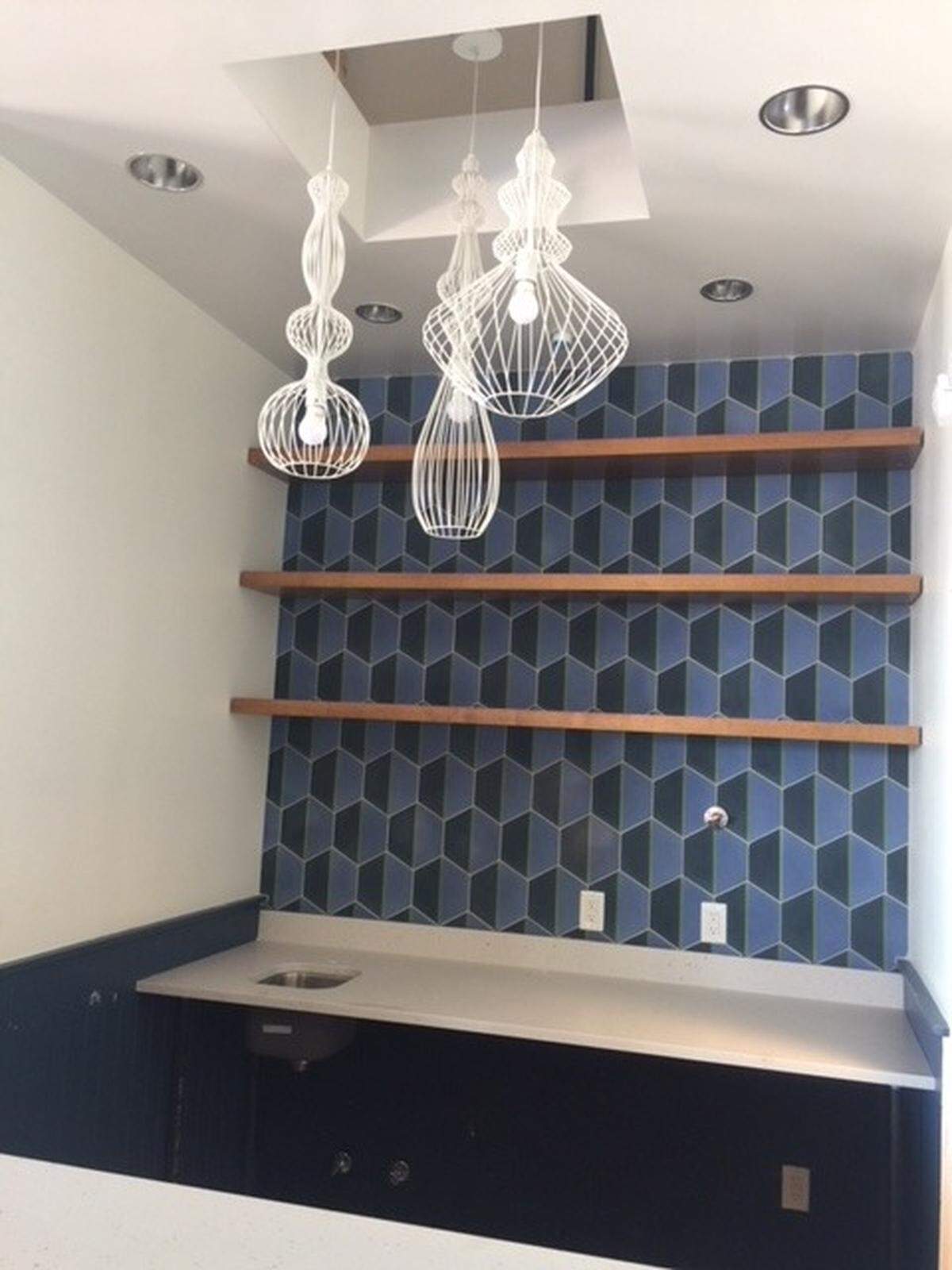 The new cooking school includes a blue and green color scheme with contemporary fixtures. To come: 55-inch TVs to display the cooking moves during classes.