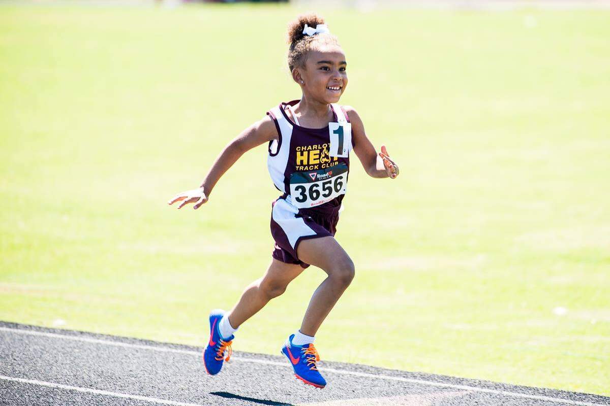 Mylan Clay smiles through a race she ran during her first year with the Charlotte Heat Track Club, in 2016.