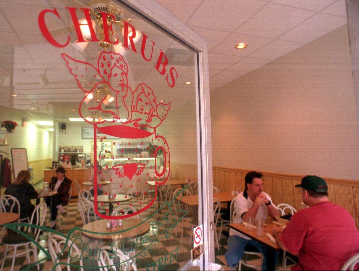Customers Jeff Beard, left, and Dan Wright enjoy a cup of espresso at Cherubs Craft & Coffee Shop on Main Street in Belmont in January 1997.