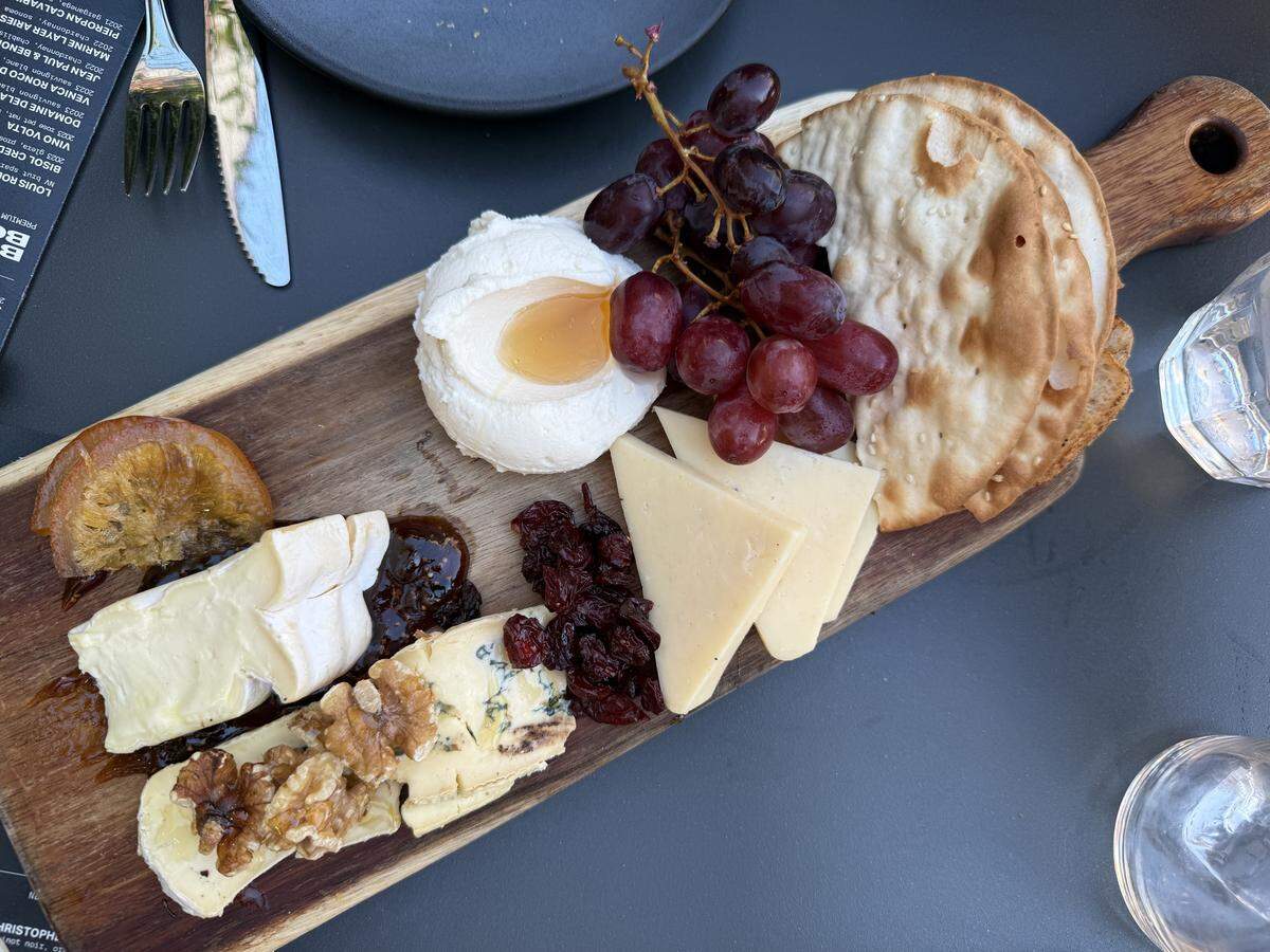 Postino’s Table Cheese board is a rotating selection of cheeses with whipped ricotta & Calabrian honey, seasonal jam, honey, toasted nuts and crisp breads.