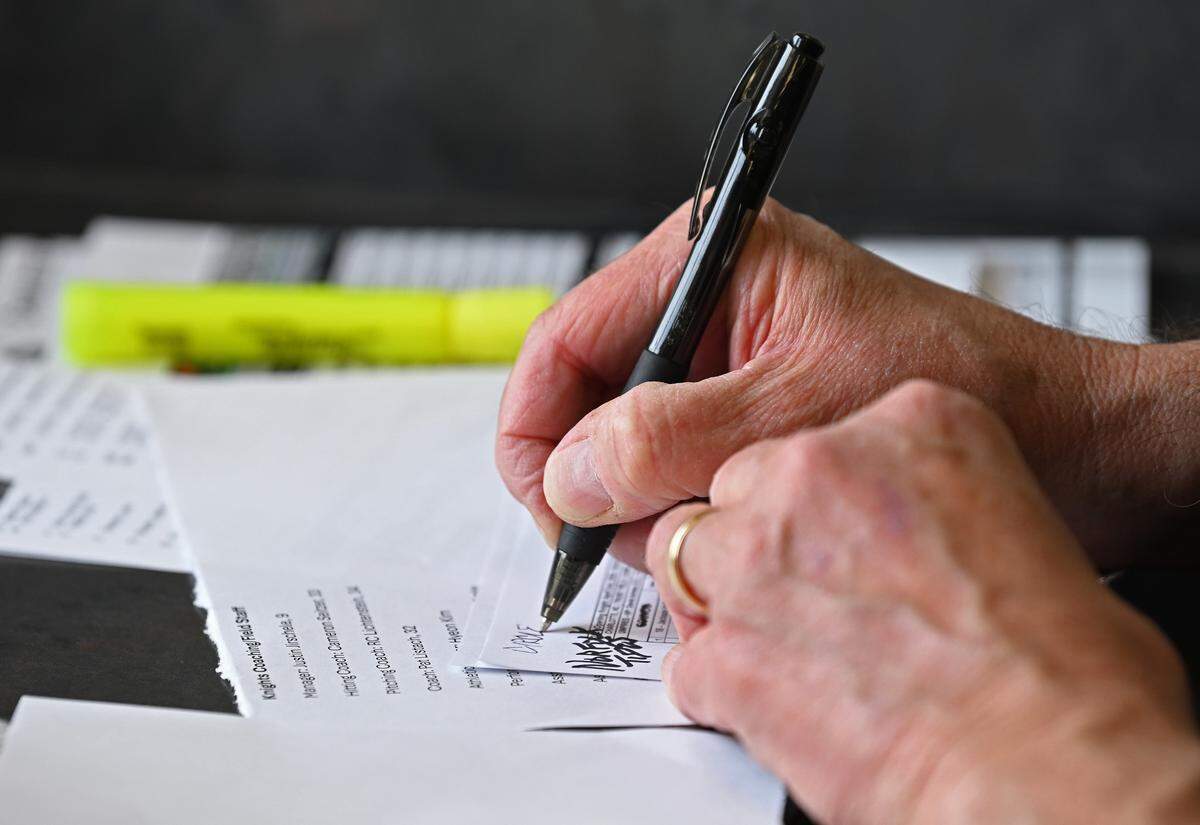 Charlotte Knights public address announcer Ken Conrad makes some quick notes prior to the team’s home opener against the Norfolk Tides on Tuesday, April 2, 2024 at Truist Field in Charlotte, NC. Conrad has been with the team for 23-years.