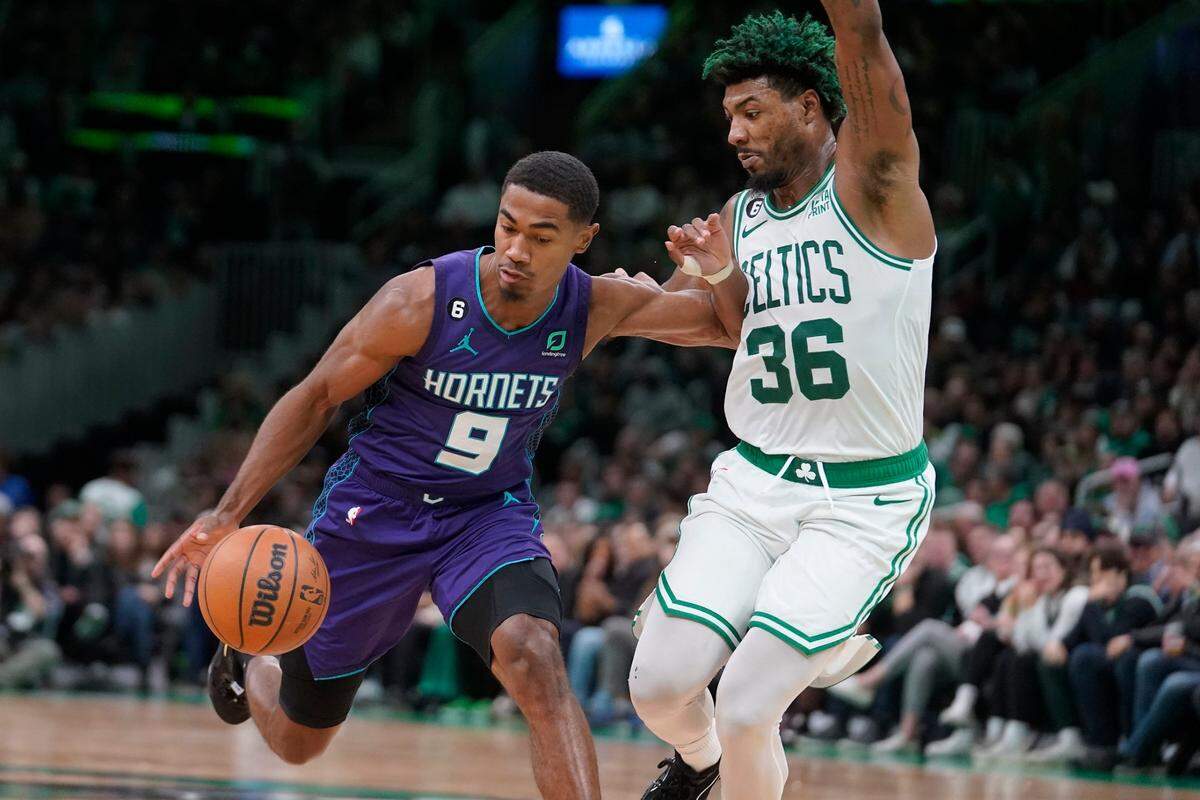 Charlotte Hornets guard Theo Maledon (9) tries to drive past Boston Celtics guard Marcus Smart (36) during the second half of an NBA basketball game, Monday, Nov. 28, 2022, in Boston. (AP Photo/Steven Senne)