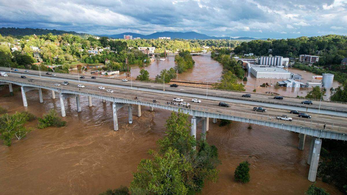 The French Broad River breaks its banks in Asheville on Friday, Sept. 27, 2024 as the remnants of Hurricane Helene caused flooding, downed trees, and power outages in western North Carolina.