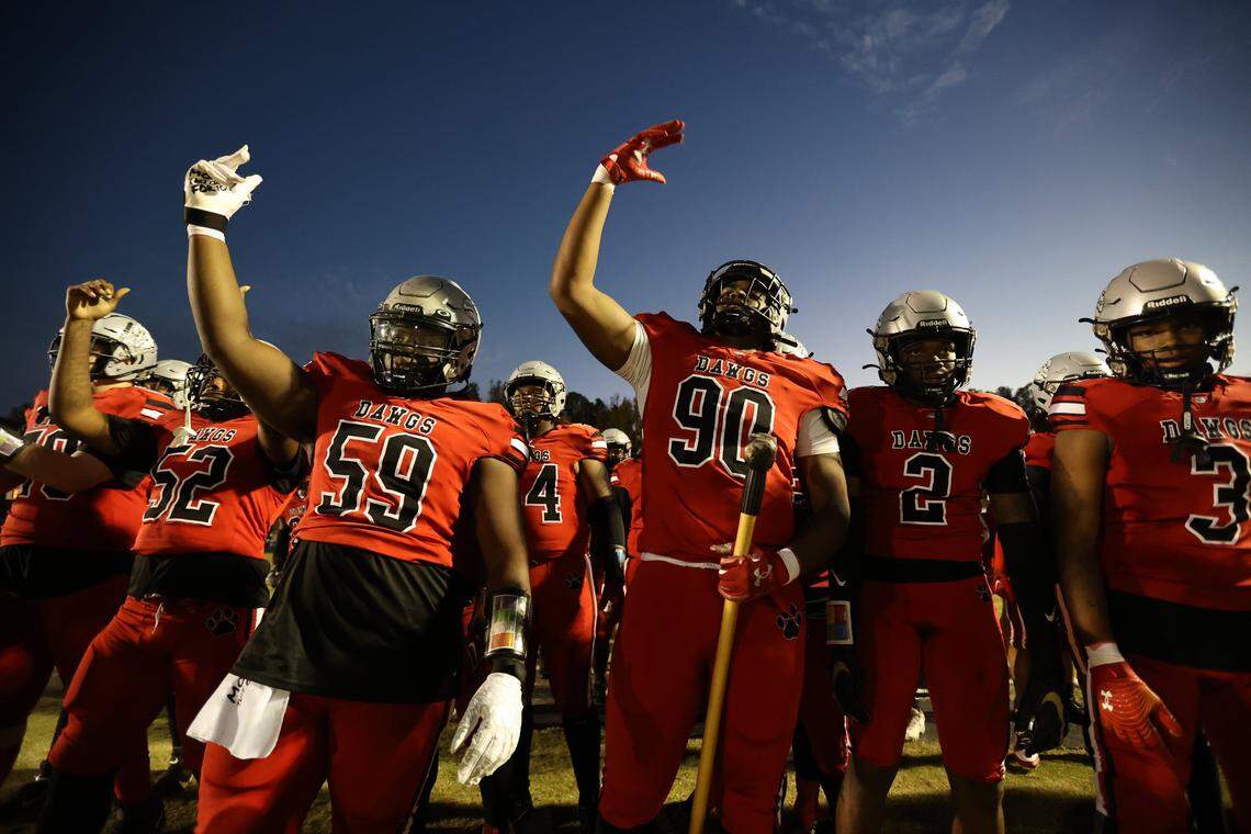 Butler’s Jadyn Farmer (90) and Caleb Scull (59) get ready to take the field with the team before taking on the Independence Patriots for the Southwestern 4A title at Butler High School on October 27, 2023.