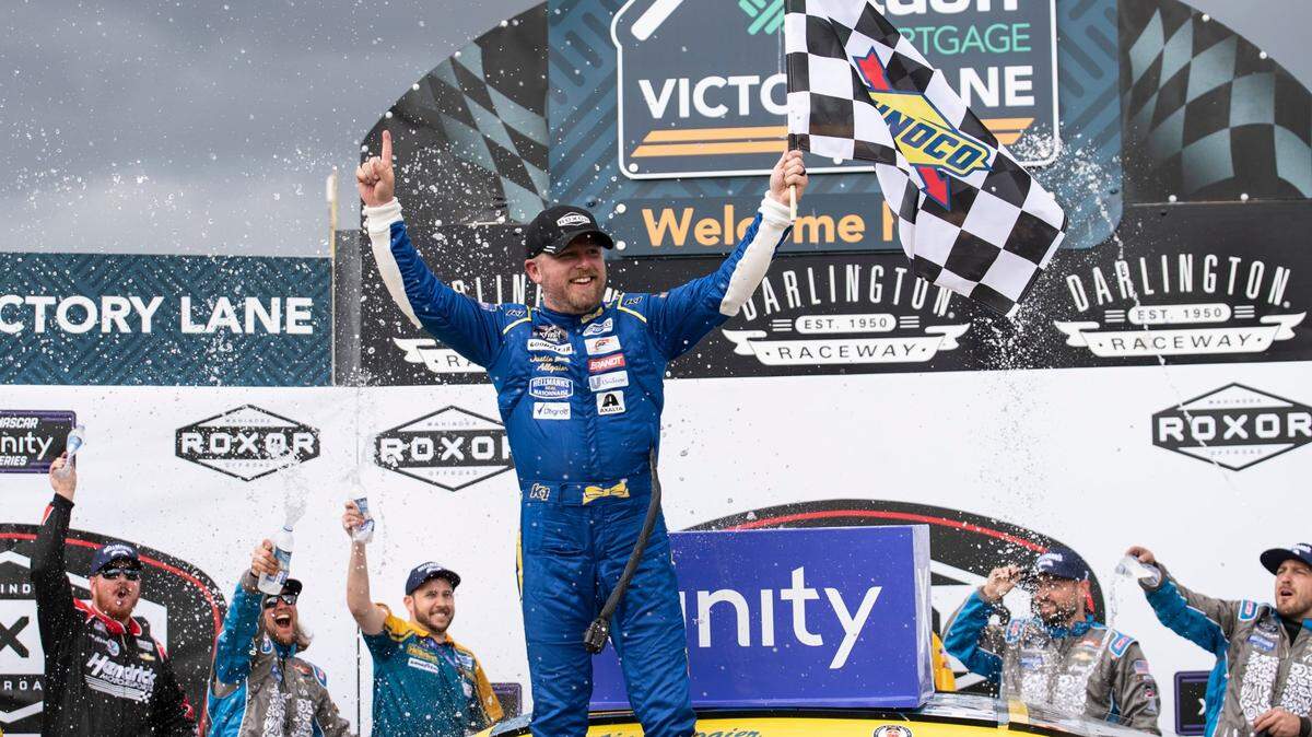 Justin Allgaier (7) celebrates in Victory Lane after winning the NASCAR Xfinity auto race at the Darlington Raceway on Saturday, May 7, 2022, in Darlington, S.C. (AP Photo/Matt Kelley)
