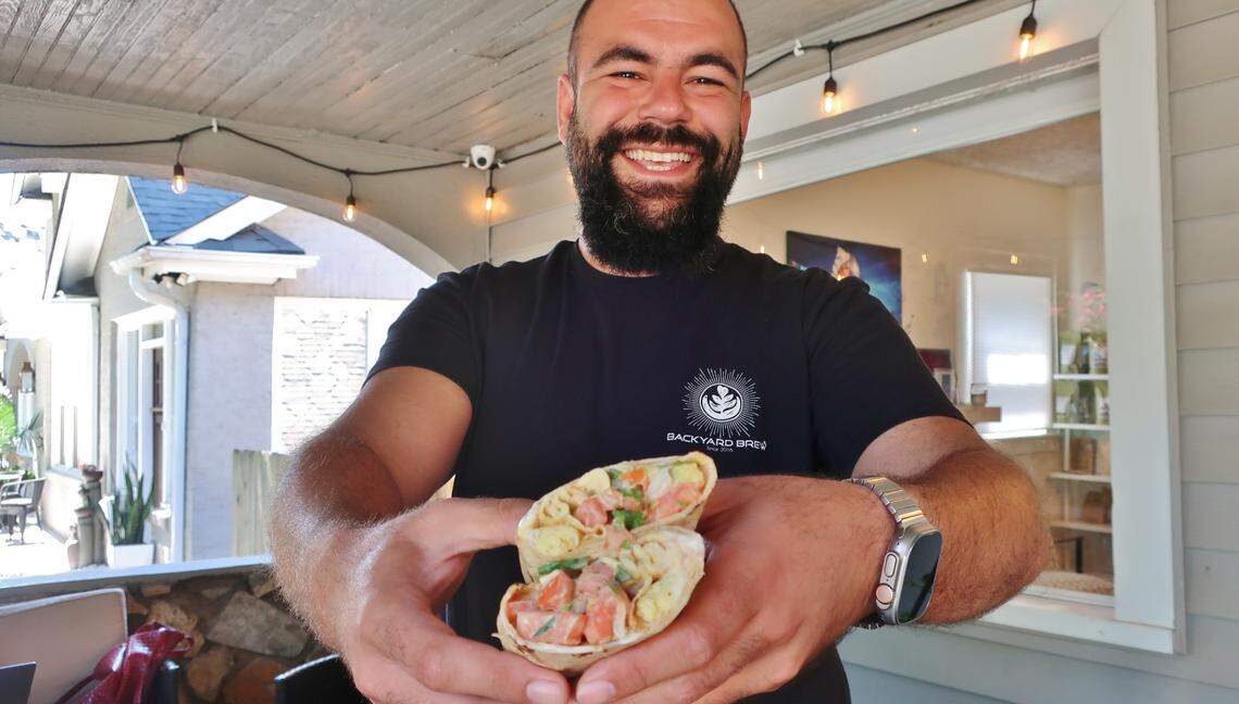 Inside a historic Dilworth home on East Boulevard, Backyard Brew brings customized coffee and community to Charlotte. Co-owner Ryan Khalil is shown on the front porch.
