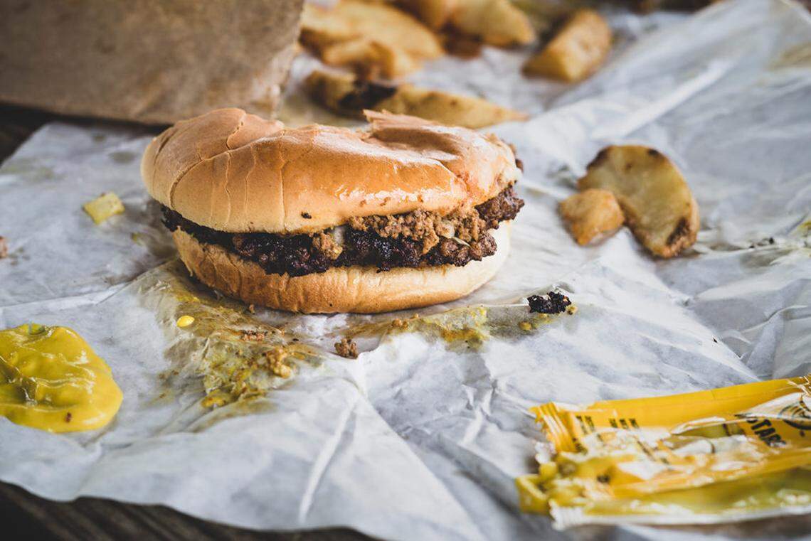 Brooks’ burger “all-the-way” includes mustard, onion and chili.