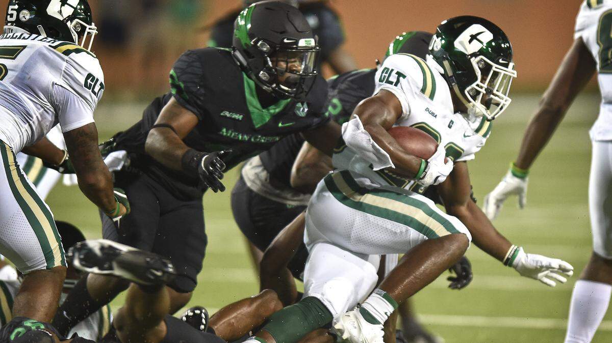 Charlotte's Tre Harbison picks up yardage against North Texas.
