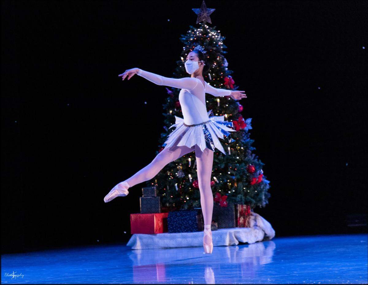 Charlotte Ballet II dancer Meredith Hwang performs on stage in a mask during a December 2020 performance of “A Fairy-Tailored Nutcracker.” Hwang auditioned for Charlotte Ballet II just as the pandemic began. She got the job and moved to Charlotte last summer, but did not meet her colleagues in person until October.