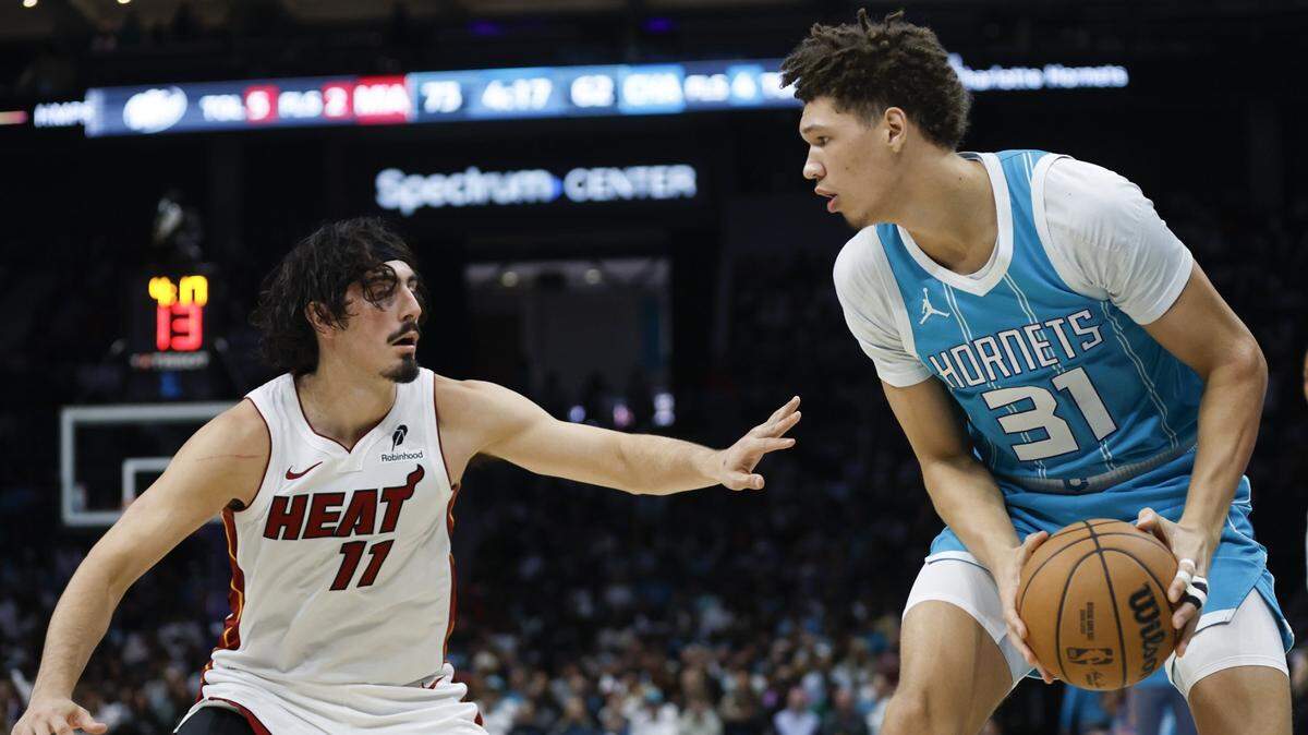 Charlotte Hornets forward Tidjane Salaun (31) looks to pass against Miami Heat guard Jaime Jaquez Jr. (11) during the second half at Spectrum Center.
