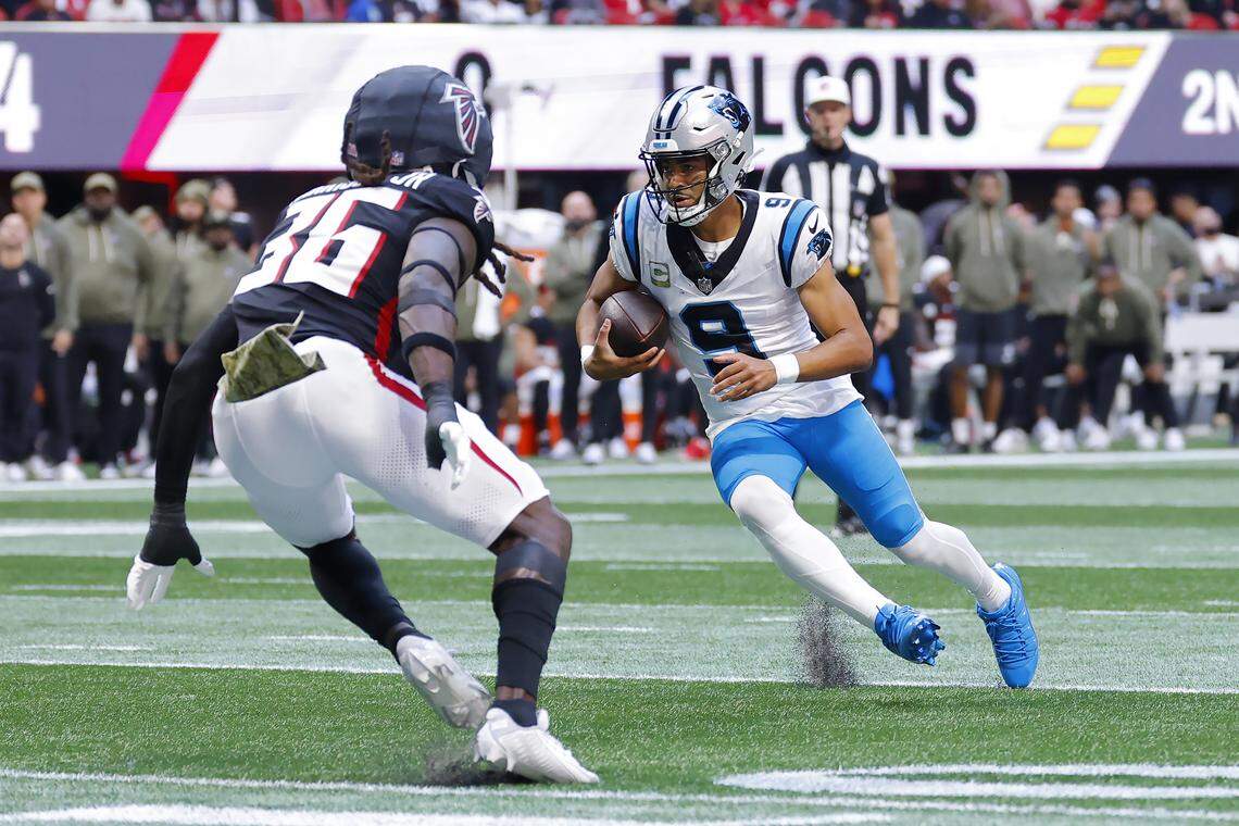Carolina Panthers QB Bryce Young runs the ball against Ronnie Harrison Jr. of the Atlanta Falcons during Sunday’s first quarter at Mercedes-Benz Stadium in Atlanta.